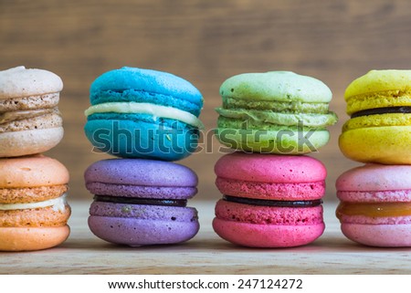 macaroons on table over wooden background. 