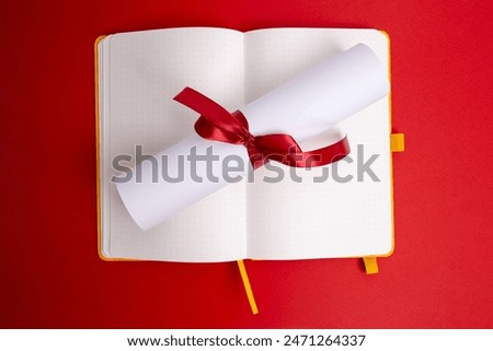 Diploma tied with a red ribbon on a colored background. Education and science concept