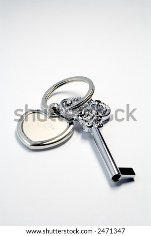 Metaphoric "key to heart" lying on white paper background
