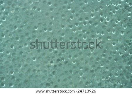 A glass texture with bubbles and black specs