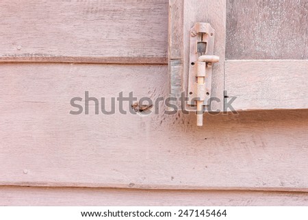 window latch on a old grungy timber
