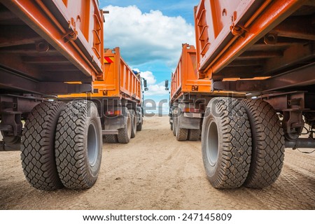 view through two rows of tippers close up Royalty-Free Stock Photo #247145809