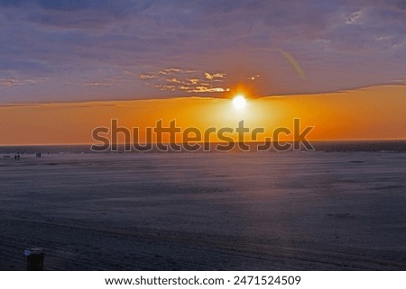 Panoramic picture over the beach of Ouddorp in Holland in the evening during sunset in summer