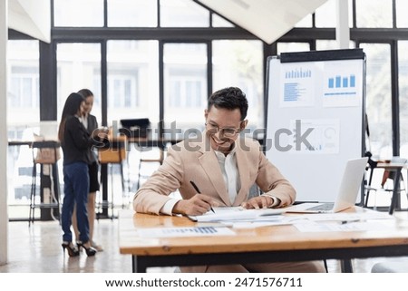 Asian accounting man working with document paper and laptop computer at table office, Financial and accounting concept. 