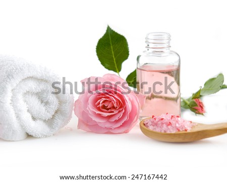 Spa setting with rose ,salt in spoon, oil with towel