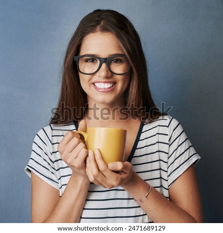 Woman, student and coffee in studio with portrait, smile and drink on blue background. Mug, caffeine and hot chocolate for learner person, hands and matcha latte or green tea for hydration and relax