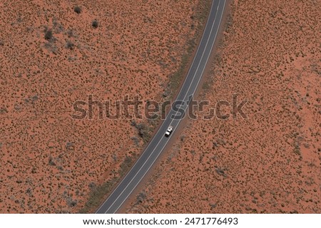 A car travels alone in the vast Australia's outback