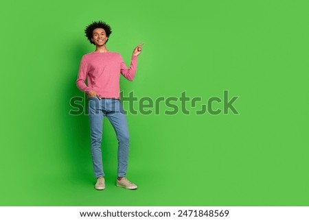 Full length photo of funky cool guy dressed pink pullover showing finger emtpy space isolated green color background
