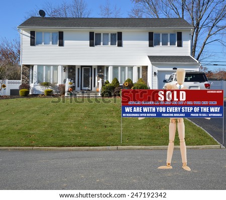 Mannequin holding Real estate sold (another success let us help you buy sell your next home) sign White Suburban High Ranch home clear blue sky autumn day residential neighborhood USA