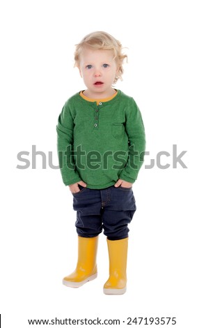 Adorable blond baby with yellow gumboots isolated on a white background