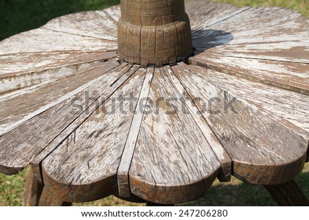 Outdoor wooden table and chairs in yard.