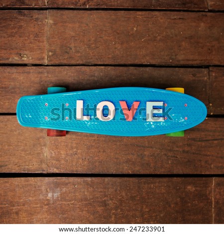 word love made up of colorful wooden letters on the blue penny board. February 14, Valentine's Day