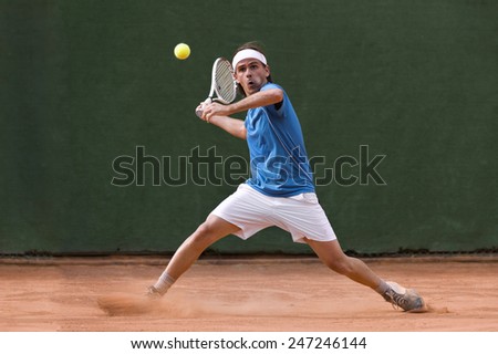 Male tennis player in action Royalty-Free Stock Photo #247246144