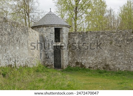 Ancient round dovecote in the corner of a walled garden