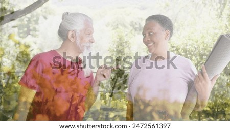 Image of spots of light and trees over diverse senior people talking in garden. Yoga, senior lifestyle, fitness, active lifestyle and retirement concept digitally generated image.