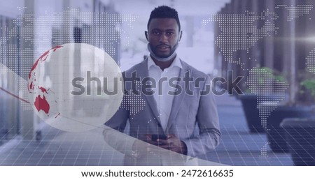 Image of financial data processing over african american businessman in office. Global finance, business, connections, computing and data processing concept digitally generated image.