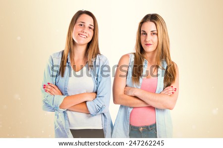 Girls with her arms crossed over ocher background 
