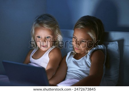 Tablet, bedroom and children in home at night for streaming movie, video and cartoon. Digital technology, girls and kids in bed for game, internet and sisters reading story online to relax together