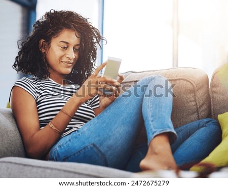 Woman, smartphone and browsing on sofa in living room with social media or app for relax on weekend.Person, smile and house with internet for communication or search with blog, reading and texting.