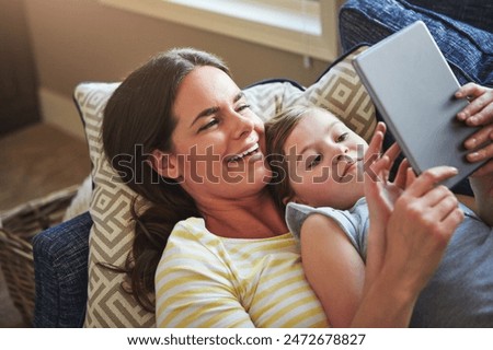 Tablet, mother and girl on sofa with internet for reading ebook, relationship love and streaming animation for fun in home. Child, mama and tech on couch with website for learning language and games