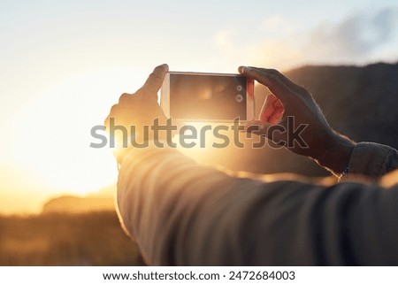 Sunset, phone and hand of person with picture for travel blog, update and memory of holiday. Sky, nature and screen of technology with photography in evening for social media, post and adventure