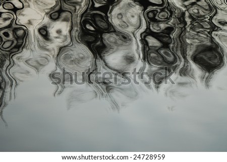 Composition from rhythmical waves on a surface of water of contrast grey color