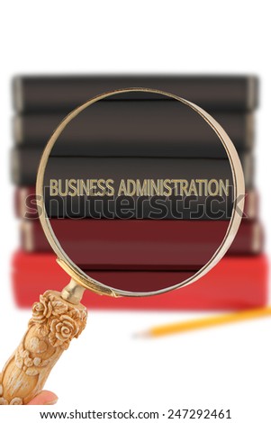 Magnifying glass or loop looking on an educational university subject - Business Administration