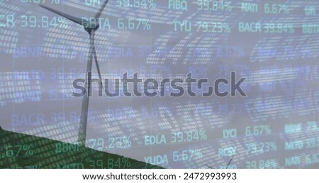 Image of financial data processing over wind turbine in countryside. Global environment, green energy and sustainability concept digitally generated image.