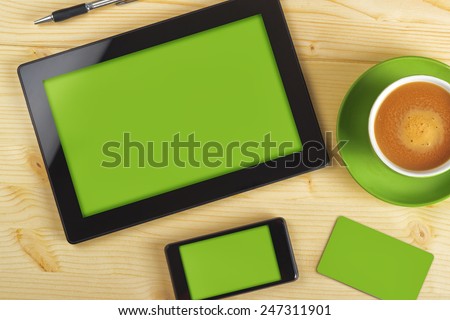 Top View of Tablet Computer, Mobile Phone And Business Card with Green Background as Copy Space for Corporate Identity Mock up on Office Table.
