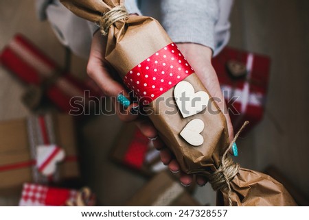 The girl holds in hands charming gift for her loved one