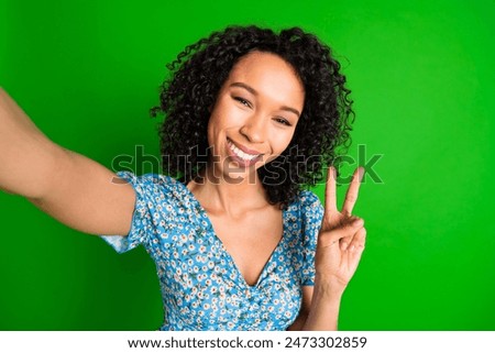 Photo of nice young woman take selfie show v-sign wear top isolated on green color background