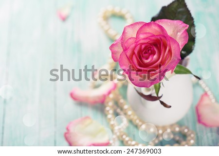 Background with fresh flower. Rose on  wooden table. Selective focus.