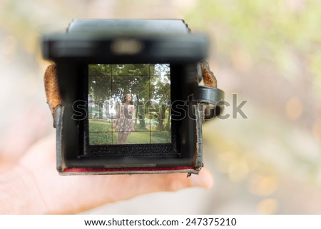 Camera with photo of young girl on the screen, selective focus