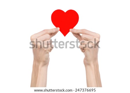 Valentine's Day and love theme: hand holding a red heart isolated on a white background in studio