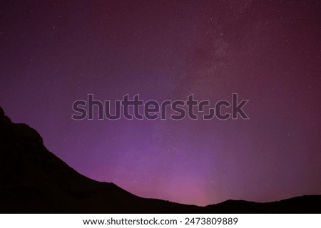 Northern Lights with Silhouette of Hills and The Milky Way