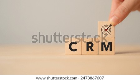 CRM, Customer relationship management concept. Customer satisfaction, retention strategies. CRM or customer loyalty program banner. Wooden cube blocks with CRM symbols on minimal background.