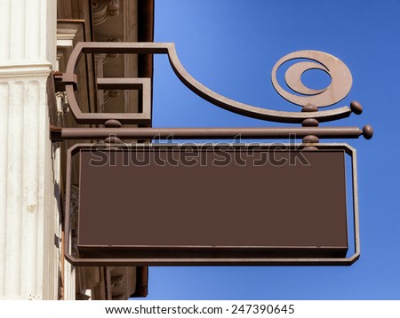 beautiful old store sign in front of sky