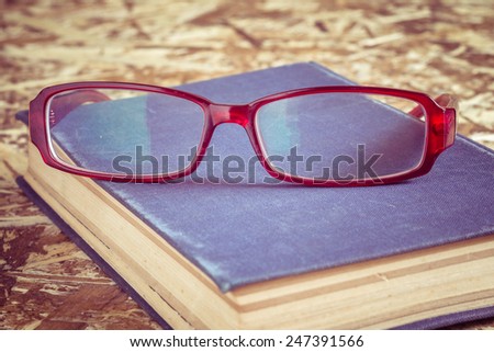 glasses and book with filter effect retro vintage style