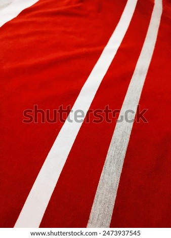 The texture and background of the fabric is white, gray and red