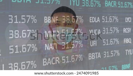 Image of financial data processing over man wearing face mask. Global covid 19, computing, finance, business and data processing concept digitally generated image.