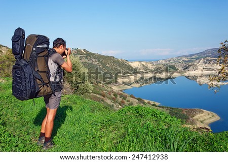 photographer take photo outdoors by the lake in spring