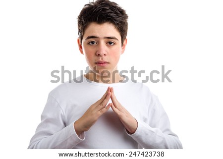 Caucasian boy with acne-prone skin in a white long sleeved t-shirt makes hand steeple gesture