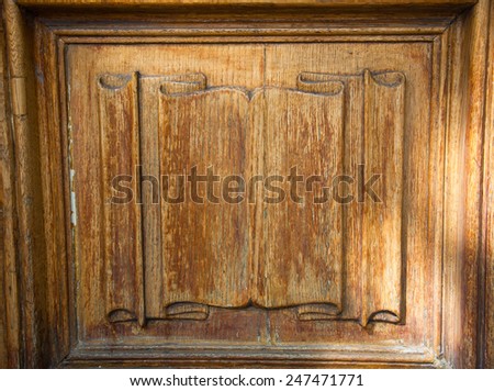 Old wooden door with carved "scroll banner".