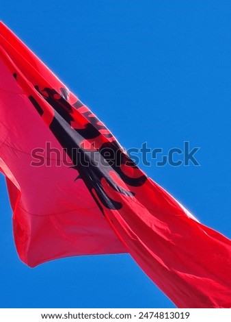 National flag of Albania on clear blue sky