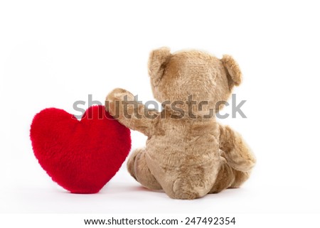Back view of a Teddy bear with red heart over white