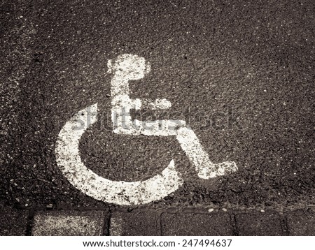 handicapped  / disabled parking sign painted on asphalt