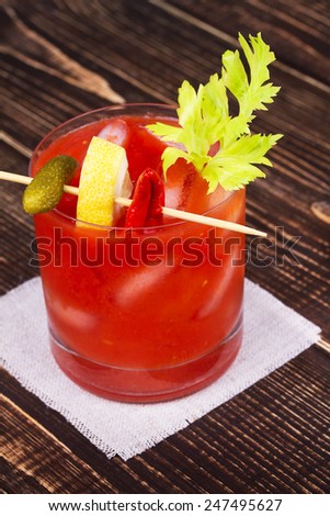Spice and Salt Bloody Mary Cocktail on wooden background