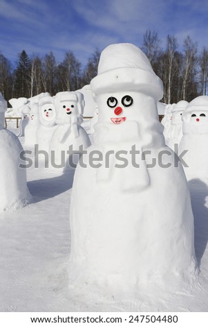 snow man in winter with forest