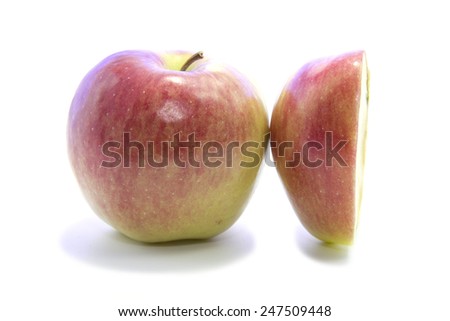 Red organic apple cross section sliced on white background