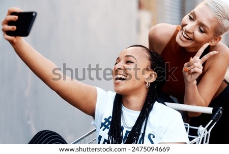 Happy woman, friends and trolley with selfie for memory, fashion shopping or peace sign in city. Female person with smile for friendship, photography or picture together with emoji in an urban town